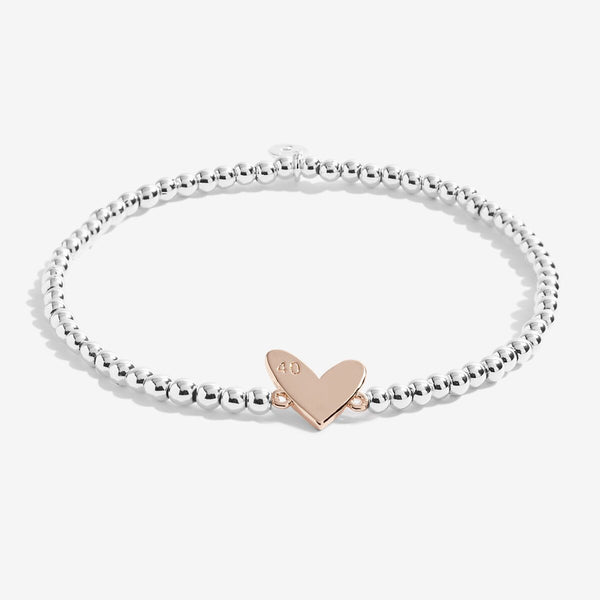 Joma Jewellery 'a little' bracelet with rose gold heart charm engraved with 40, presented on a sentiment card which reads:  'This special bracelet is just to say, have a very happy 40th Birthday'  Beautifully packaged in it's own little box, each item also comes with a Joma Jewellery gift envelope and gifting card. 