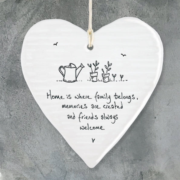 White Hanging Porcelain 'Wobbly' Heart from East of India which reads:  'Home is where family belongs, memories are created and friends always welcome '  The heart features an engraved illustration in East of India's unique style.