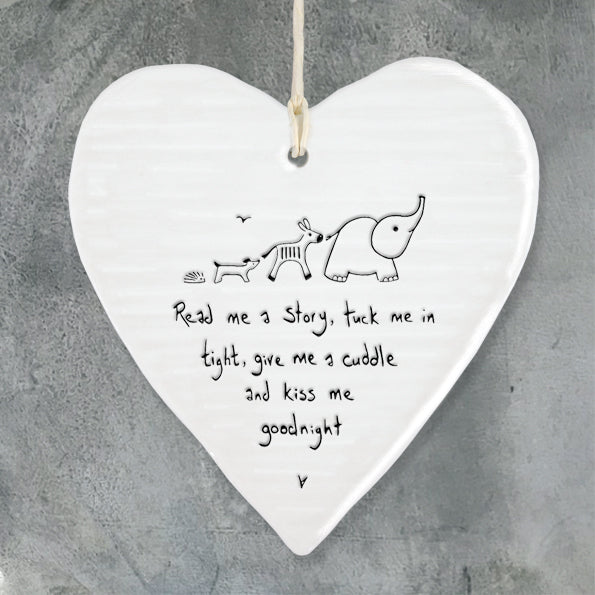 White Hanging Porcelain 'Wobbly' Heart from East of India which reads:  'Read me a story, tuck me in tight, give me a cuddle and kiss me goodnight'  The heart features an engraved illustration in East of India's unique style.