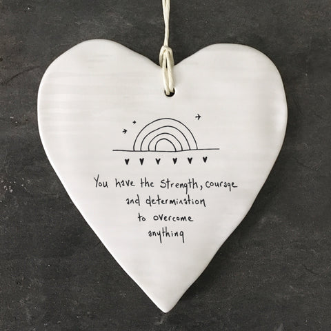 White Hanging Porcelain 'Wobbly' Round Heart from East of India which reads:  'You have strength, courage and determination to overcome anything.'  The heart features an engraved illustration in East of India's unique style.