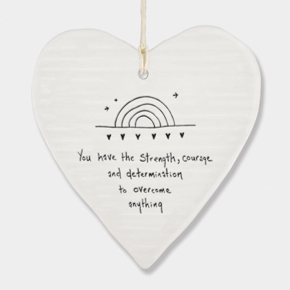 White Hanging Porcelain 'Wobbly' Round Heart from East of India which reads:  'You have strength, courage and determination to overcome anything.'  The heart features an engraved illustration in East of India's unique style.