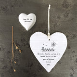 White Hanging Porcelain 'Wobbly' Round Heart from East of India which reads:  'Because someone we love is in heaven there is a little piece of heaven in our home.'  The heart features an engraved illustration in East of India's unique style.
