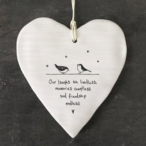 White Hanging Porcelain 'Wobbly' Round Heart from East of India which reads:  'Our laughs are limitless, memories countless and friendship endless.'  The heart features an engraved illustration in East of India's unique style.