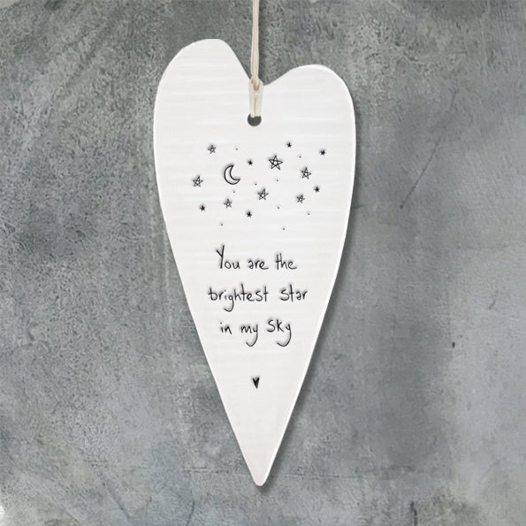 White Hanging 'Wobbly' Long Porcelain Heart from East of India which reads:  'You are the brightest star in my sky.'   The heart features an engraved illustration in East of India's unique style.