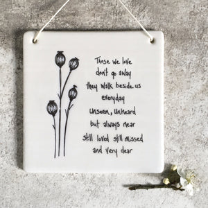White porcelain  hanging memorial sign from East of India which reads:  'Those we love don't go away  they walk beside us everyday  unseen unheard but always near  still loved still missed and very dear'