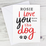 This personalised card features the wording 'I Love You More Than The Dog' and cute pawprint graphics 