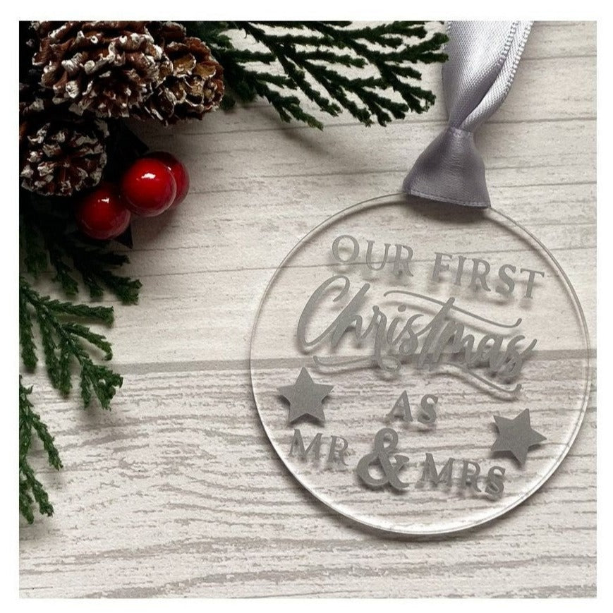 Acrylic disc Christmas decoration.  The decoration is mounted on card and packaged in clear cellophane packets with a sticker of the branding.   'First Christmas as Mr & Mrs' printed on permanent vinyl.