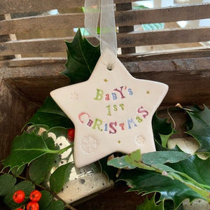 Hand painted ceramic star featuring star design and the sentiment 'Baby's 1st Christmas'
