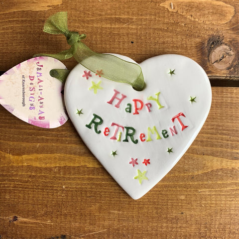 Hand painted ceramic heart featuring stars design and the sentiment 'Happy Retirement'