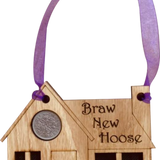A unique keepsake gift with a Scottish twist.  The sixpence is mounted onto a hanging oak veneered wooden house with tartan inserts, mounted on card and packaged in clear cellophane packets.