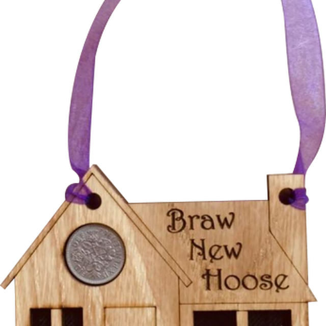 A unique keepsake gift with a Scottish twist.  The sixpence is mounted onto a hanging oak veneered wooden house with tartan inserts, mounted on card and packaged in clear cellophane packets.