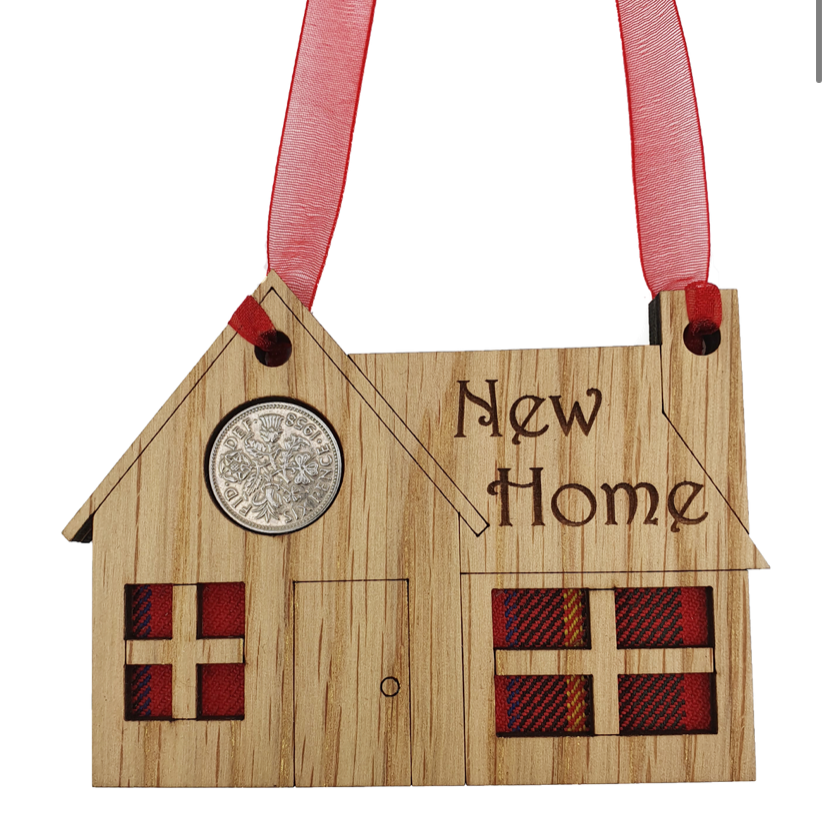 A unique keepsake gift with a Scottish twist.  The sixpence is mounted onto a hanging oak veneered wooden house with tartan inserts, mounted on card and packaged in clear cellophane packets.