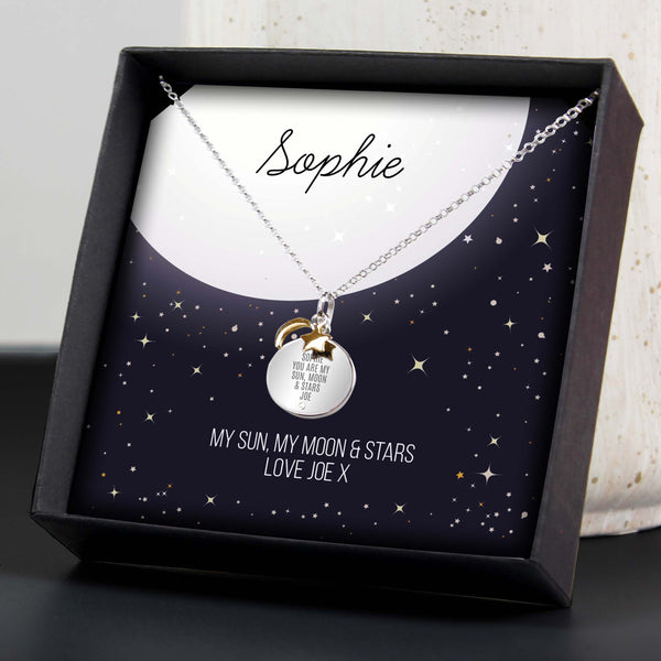 This cute personalised sterling silver necklace with gold plated moon & stars charms comes presented in it's own gift box including personalised sentiment card.  It also features a small cubic zirconia which is inset below the engraving.