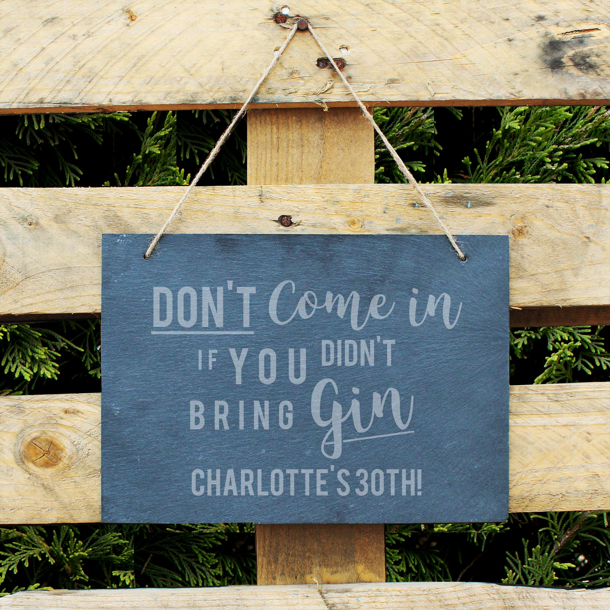 Slate hanging sign with natural, rustic string featuring the text:  'Don't come in if you didn't bring gin'  The sign can be personalised with your own choice of message up to 18 characters (all uppercase)