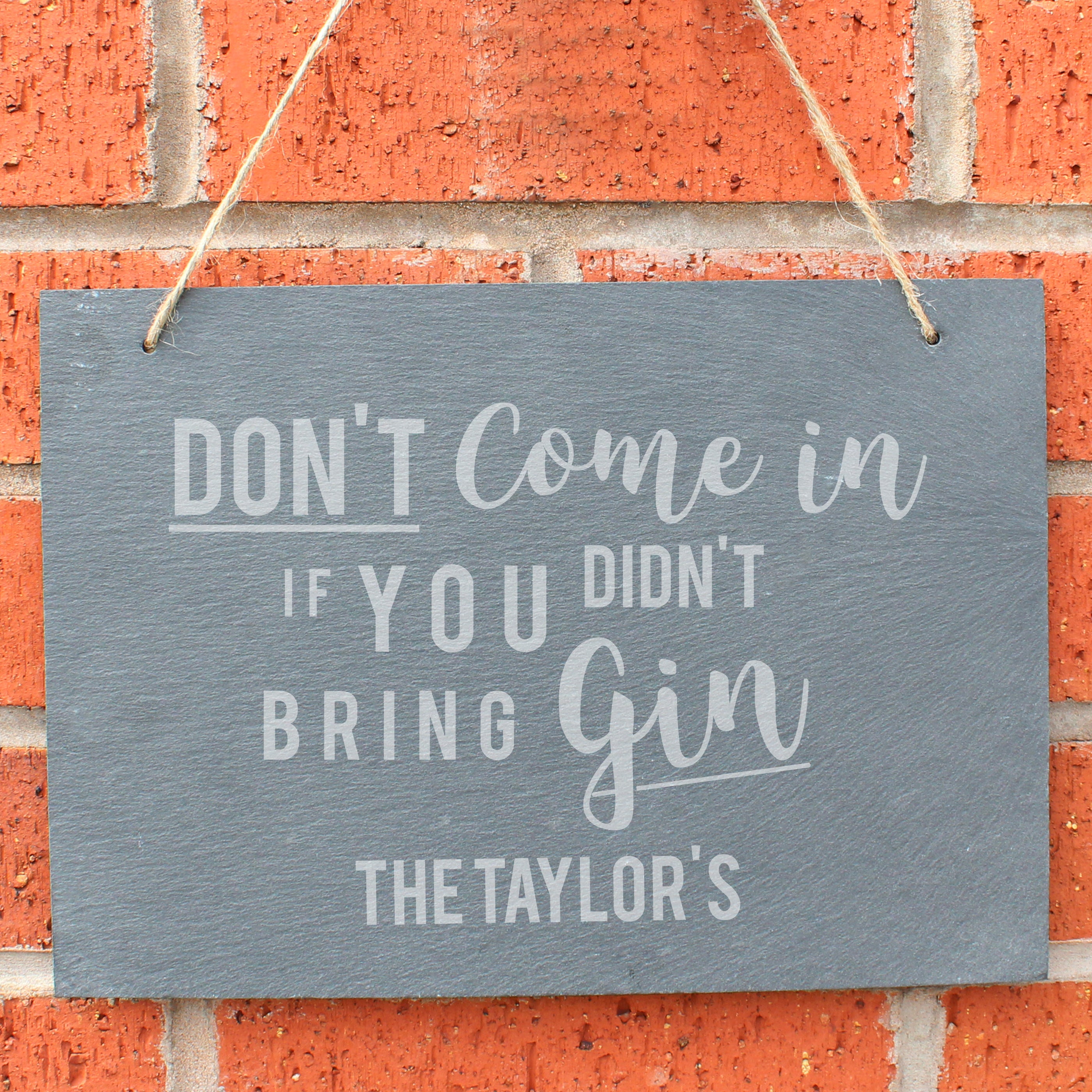 Slate hanging sign with natural, rustic string featuring the text:  'Don't come in if you didn't bring gin'  The sign can be personalised with your own choice of message up to 18 characters (all uppercase)