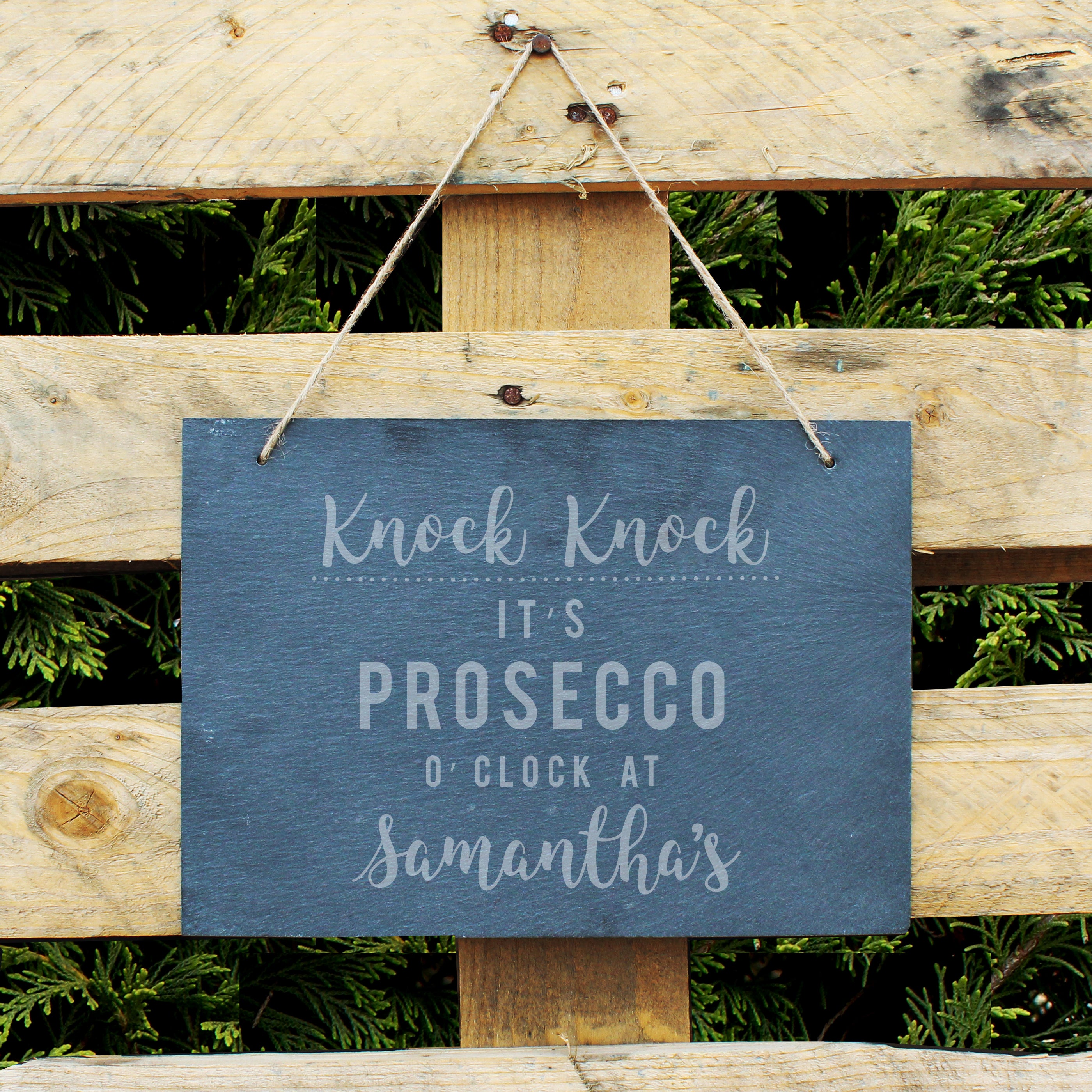 Slate hanging sign with natural, rustic string featuring the text:  'Knock Knock It's Prosecco o'clock at''  The sign can then be personalised with any name(s) up to 15 characte