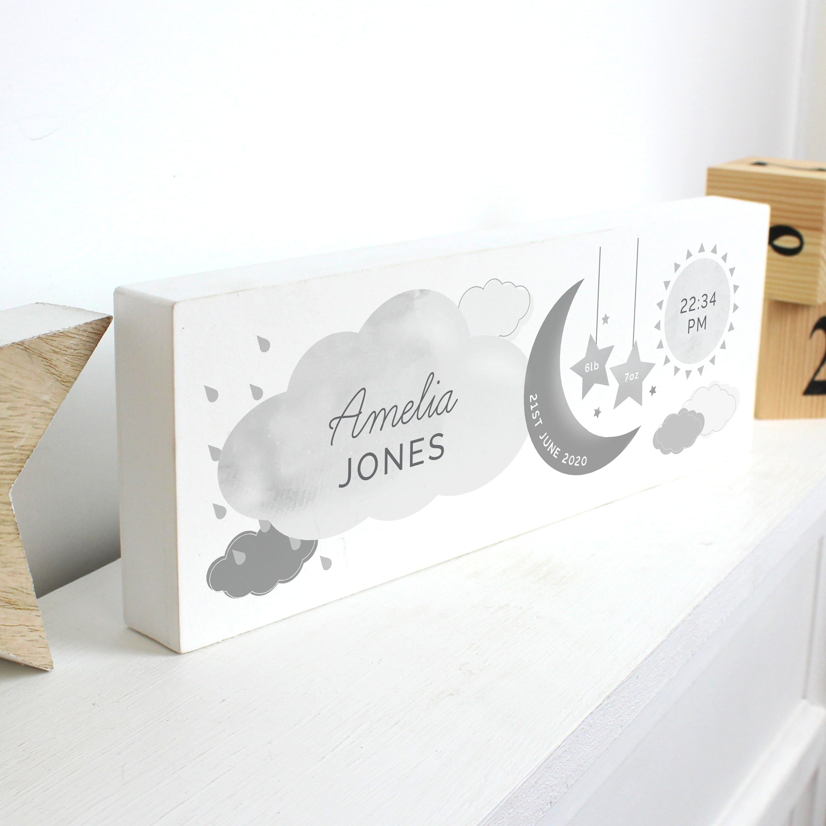 Adorable personalised moon & stars wooden block decoration, a fabulous way of welcoming a new baby to the world.  This sign can be personalised with a first name with 12 characters which is case sensitive and surname with 12 characters which is fixed upper case (on cloud). Date: 20 characters (on moon) Fixed upper case. Weight:  4 characters (on left star) and 4 characters (on right star) Case sensitive. Time : 5 Characters (on sun) with AM/PM Fixed upper case.