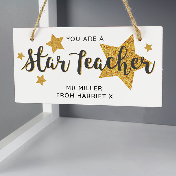 Beautiful wooden hanging sign 'Star Teacher' would make a lovely gift for all the teachers out there.  Personalise this decoration with a name up to 20 characters long and a message with up to 20 character. 'You are a star teacher' is fixed text and cannot be changed.  The personalisation will appear in fixed upper case.