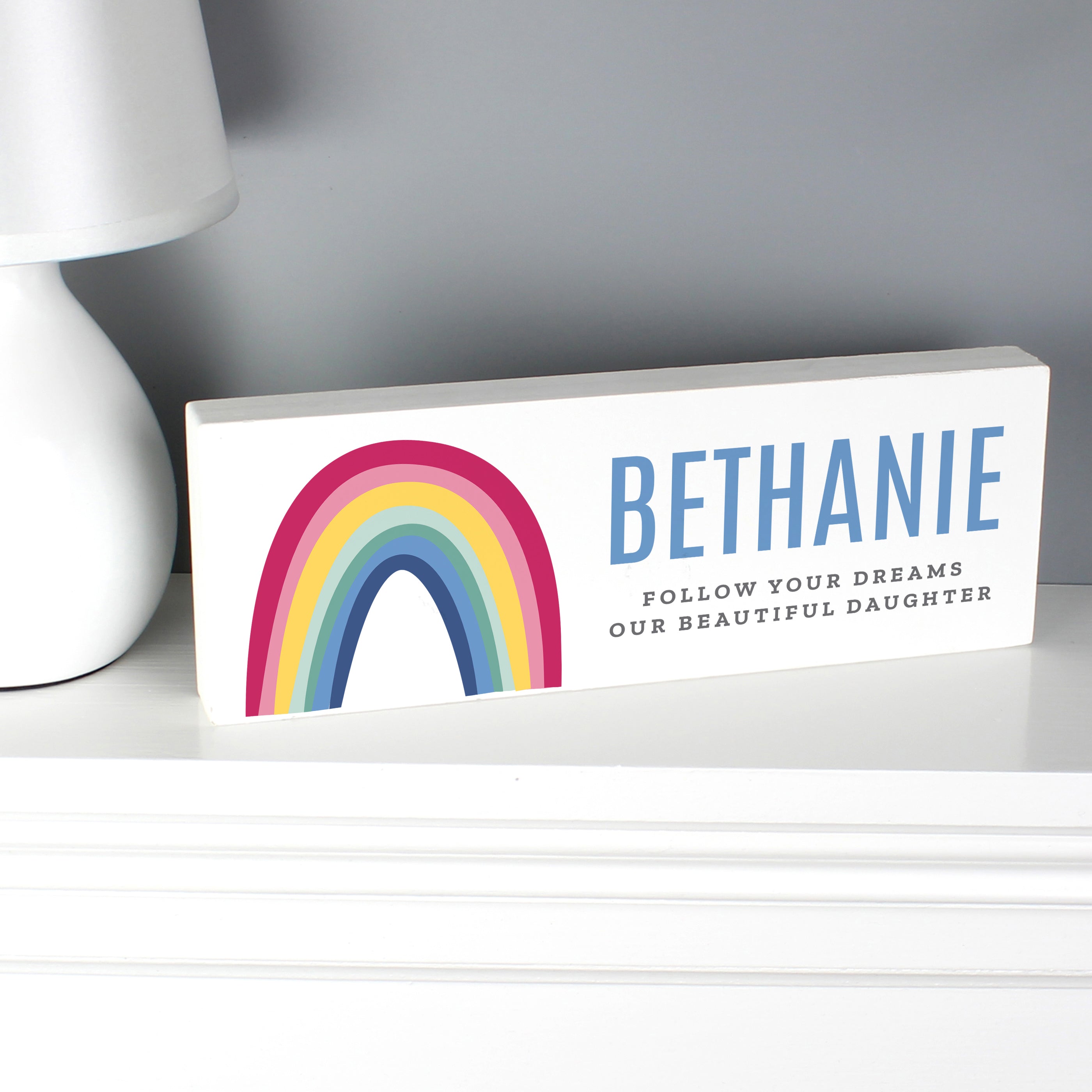 Freestanding wooden sign with bright rainbow design which can be personalised with a name up to 12 characters and your own message over 2 lines up to 25 characters per line including spaces and punctuation.