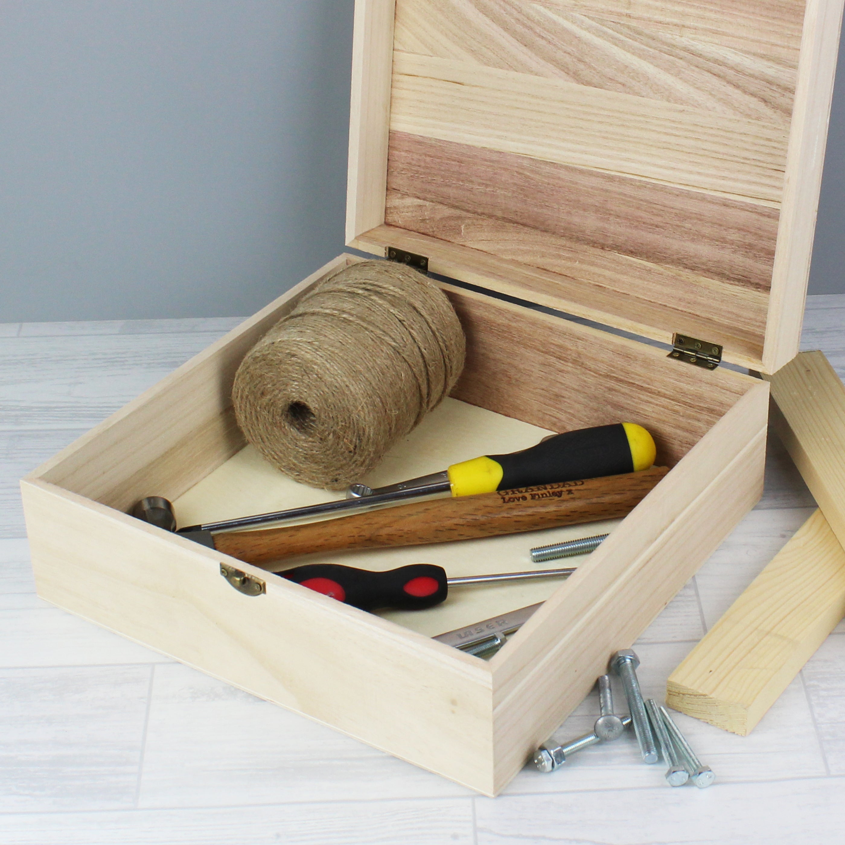 Quirky wooden keepsake box to keep his clutter at bay featuring a metal clasp and hinges. The box can be personalised with a name up to 12 characters long and will appear as entered.  It has the fixed text:  'box of man crap' Interior view
