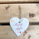 Hand painted ceramic heart featuring star design and the sentiment 'Happy 40th' Handmade in the UK using clay, glaze and paint sourced locally. Material: Ceramic