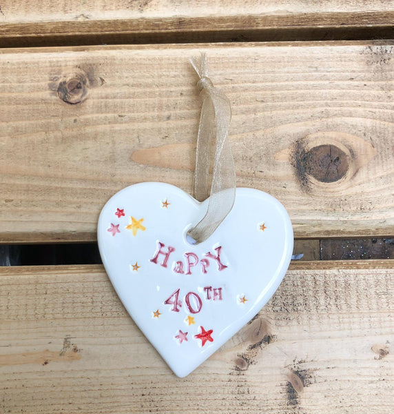 Hand painted ceramic heart featuring star design and the sentiment 'Happy 40th' Handmade in the UK using clay, glaze and paint sourced locally. Material: Ceramic