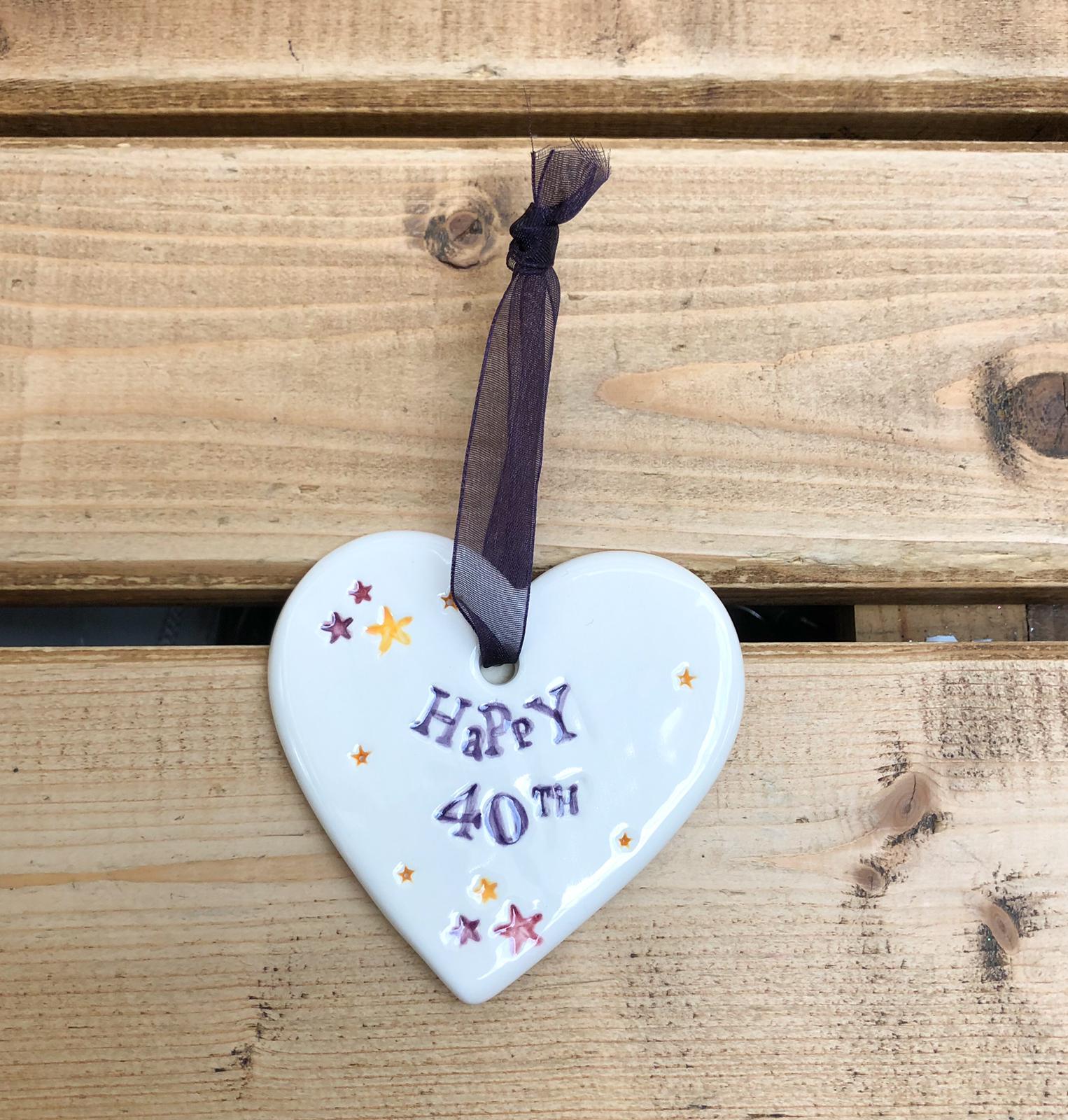 Hand painted ceramic heart featuring star design and the sentiment 'Happy 40th' Handmade in the UK using clay, glaze and paint sourced locally. Material: Ceramic