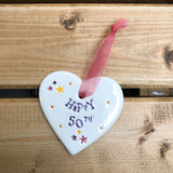 Hand painted ceramic heart featuring star design and the sentiment 'Happy 50th' Handmade in the UK using clay, glaze and paint sourced locally. Material: Ceramic