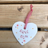 Hand painted ceramic heart featuring star design and the sentiment 'Happy 60th' Handmade in the UK using clay, glaze and paint sourced locally. Material: Ceramic