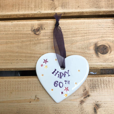 Hand painted ceramic heart featuring star design and the sentiment 'Happy 60th' Handmade in the UK using clay, glaze and paint sourced locally. Material: Ceramic