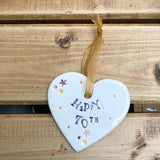 Hand painted ceramic heart featuring star design and the sentiment 'Happy 70th' Handmade in the UK using clay, glaze and paint sourced locally. Material: Ceramic