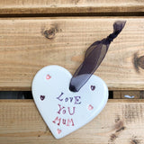 Hand painted ceramic heart featuring a flower design and the sentiment 'Love You Mum'  Handmade in the UK using clay, glaze and paint sourced locally.  Material:  Ceramic