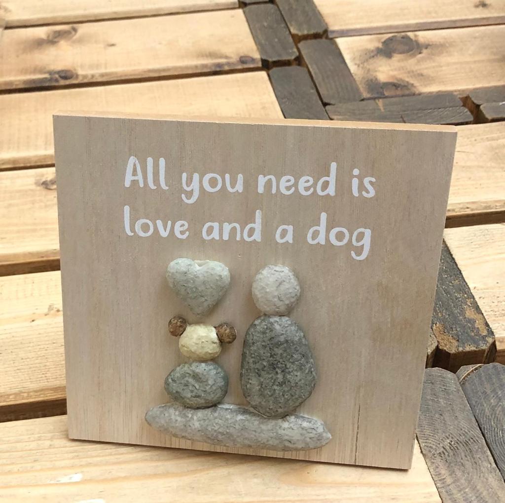 This wooden pebble plaque which reads 'All you need is love and a dog' would make a fabulous addition to your own home or a lovely gift for dog lovers.  The plaque features pebble design of a person and dog and is freestanding.