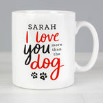 Personalised mug features the text "I love you more than the dog" on the front in red and black text with cute paw print design