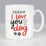Personalised mug features the text "I love you more than the dog" on the front in red and black text with cute paw print design
