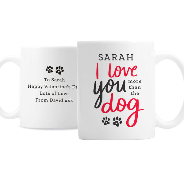 Personalised mug features the text "I love you more than the dog" on the front in red and black text with cute paw print design