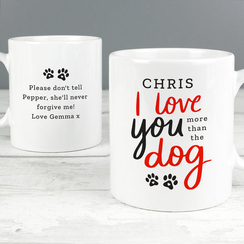 Personalised mug features the text "I love you more than the dog" on the front in red and black text with cute paw print design