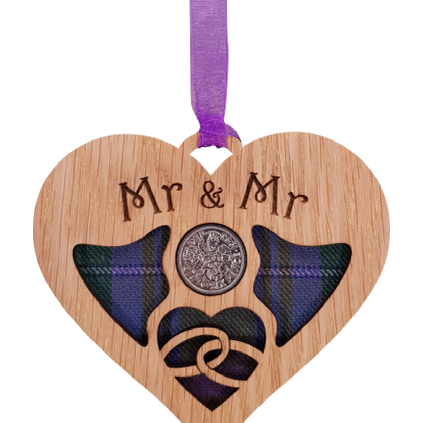 A unique keepsake gift with a Scottish twist.  The sixpence is mounted onto hanging oak veneered wooden heart with tartan inserts, mounted on card and packaged in clear cellophane packets.  The sentiment 'Mr & Mr' is engraved across the heart.