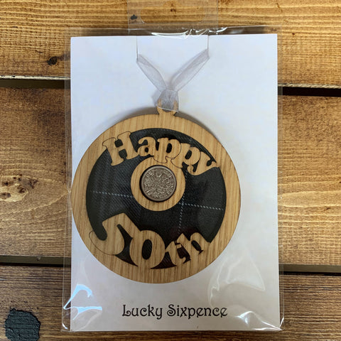 A unique keepsake gift with a Scottish twist.  The sixpence is mounted onto a round hanging oak veneered wood with tartan inserts, mounted on card and packaged in clear cellophane packets.  'Happy 50th' is cut into the wooden hanging.