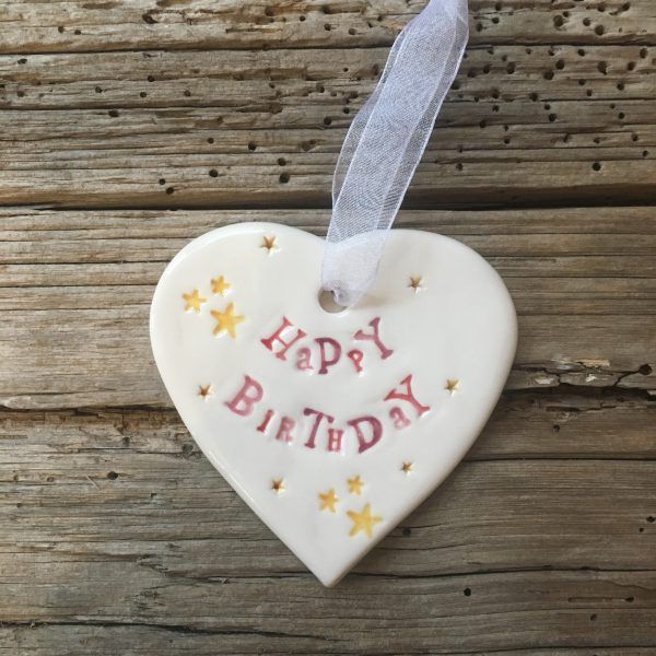 Hand painted ceramic heart featuring star design and the sentiment 'Happy Birthday'  Handmade in the UK using clay, glaze and paint sourced locally.  Material:  Ceramic