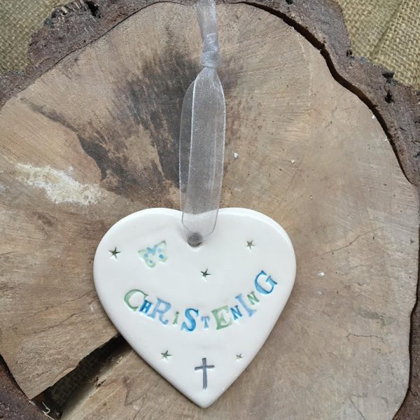 Hand painted ceramic heart featuring butterfly and stars design and the sentiment 'Christening'  Handmade in the UK using clay, glaze and paint sourced locally.  Material:  Ceramic