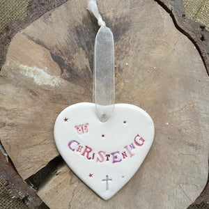 Hand painted ceramic heart featuring butterfly and stars design and the sentiment 'Christening'  Handmade in the UK using clay, glaze and paint sourced locally.  Material:  Ceramic