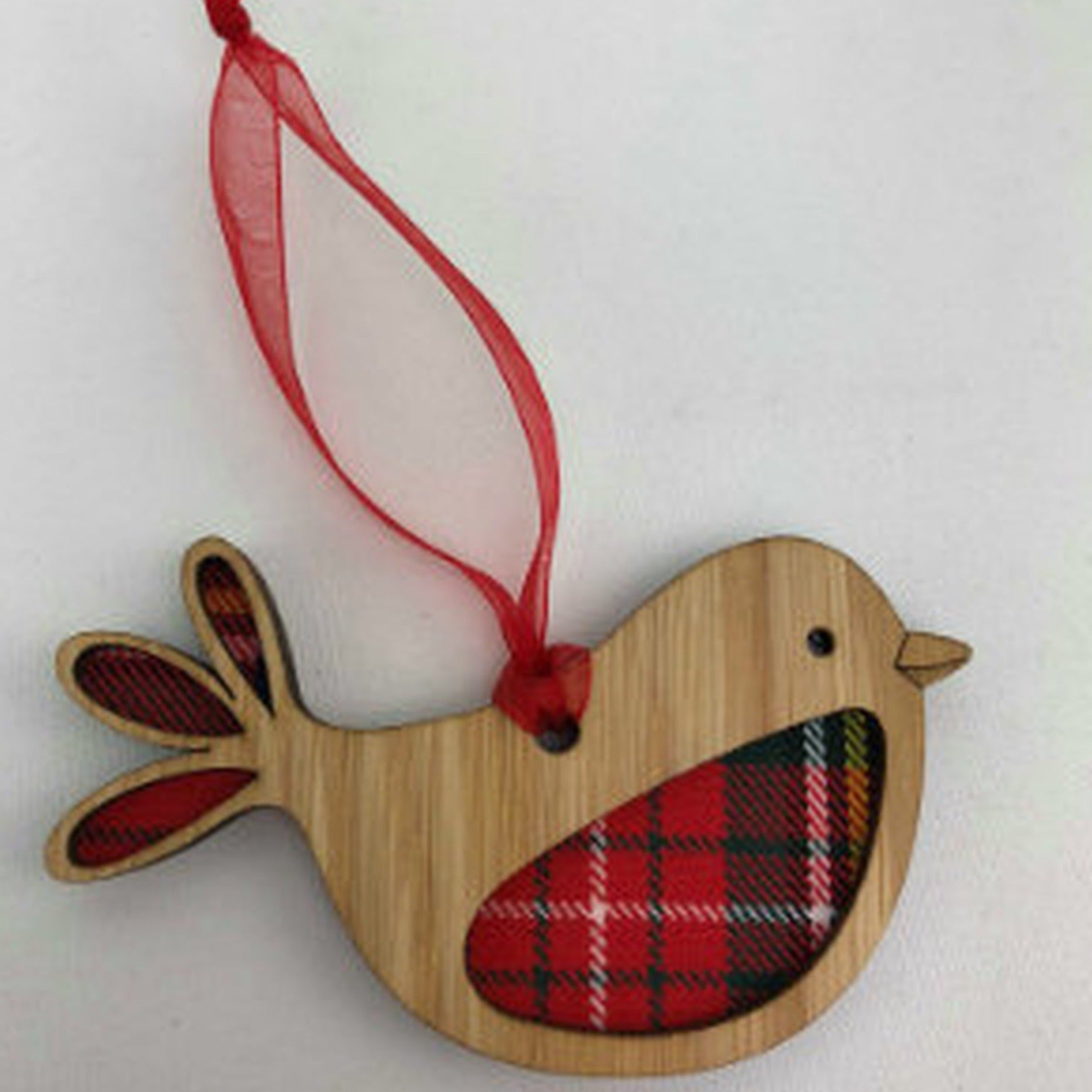 A unique keepsake Christmas decoration with a Scottish twist.  A wooden Robin with tartan inserts, mounted on card and packaged in clear cellophane packets.